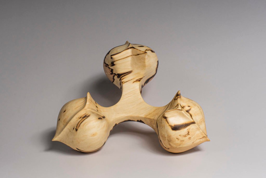 vue globale du dessus de la sculpture "Graine de Liens", création originale de Coralie Saramago, représentant trois cœurs unis, en bois de charme échauffé
